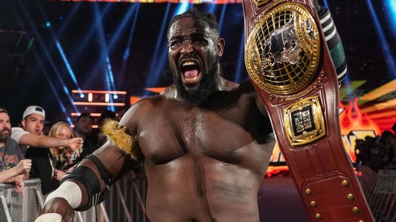 Oba Femi holds up his NXT North American Championship after a victory on "WWE NXT."