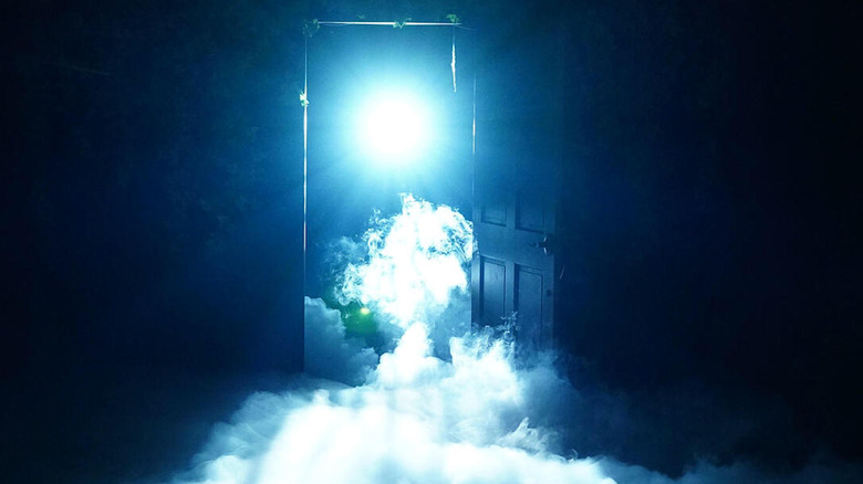 Blue light and mist coming through open door