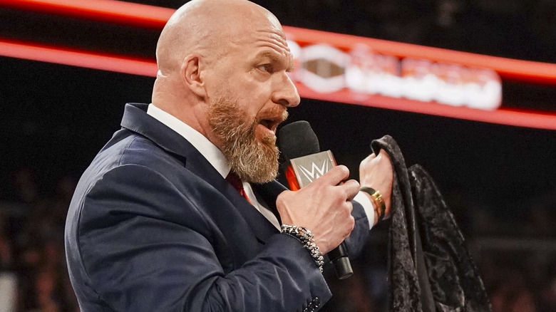 Triple H speaking into microphone