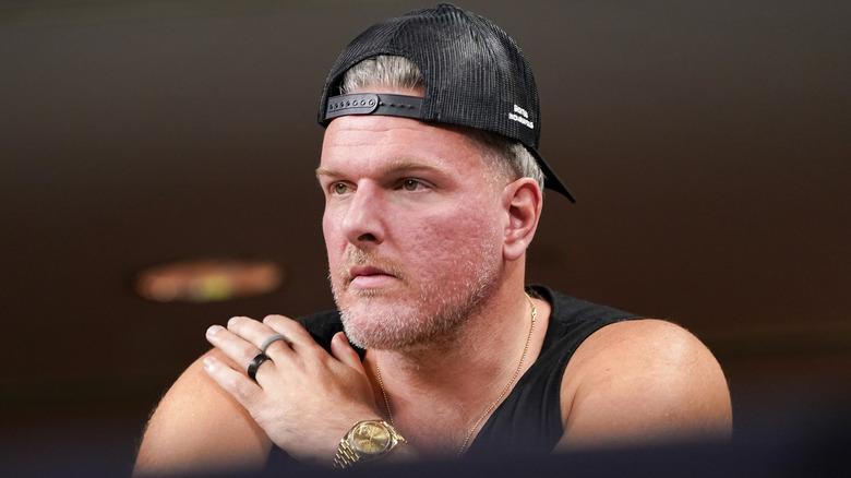 Pat McAfee wearing a backwards baseball cap