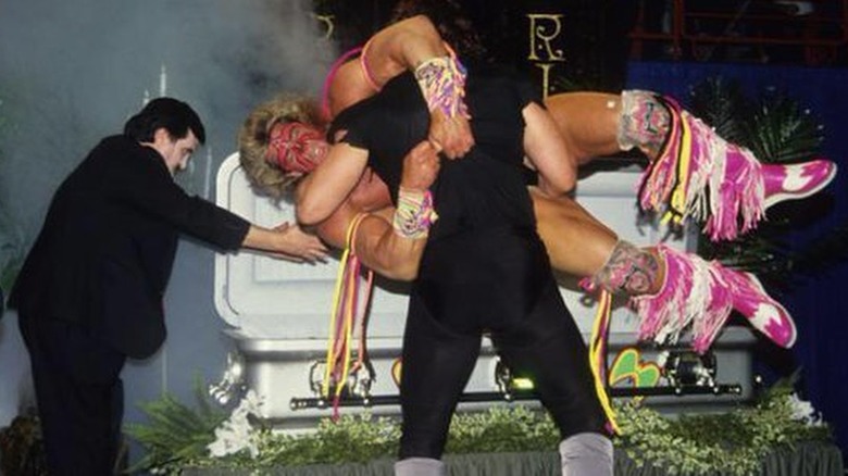 The Undertaker puts The Ultimate Warrior in coffin