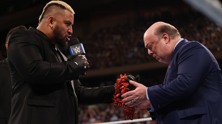 Solo Sikoa handing Paul Heyman the ula fala