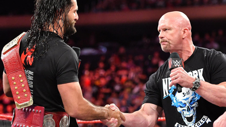 Stone Cold shakes hands with Seth Rollins