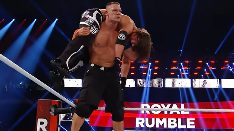 John Cena puts AJ Styles over shoulders