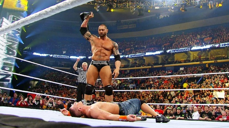 Batista standing over John Cena with the WWE Championship