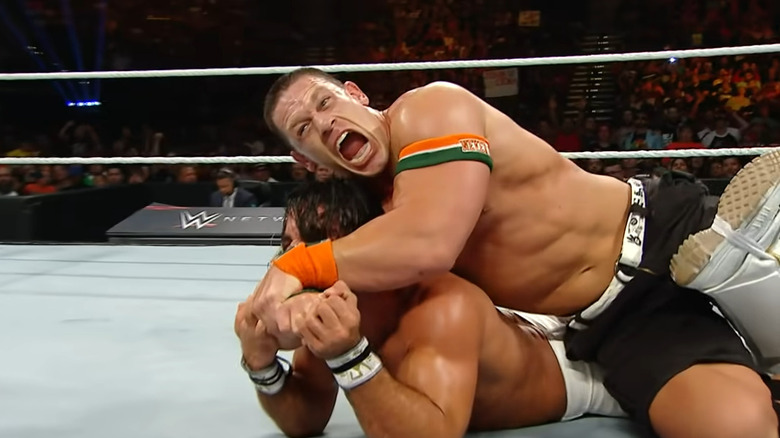 John Cena puts Rollins in STF