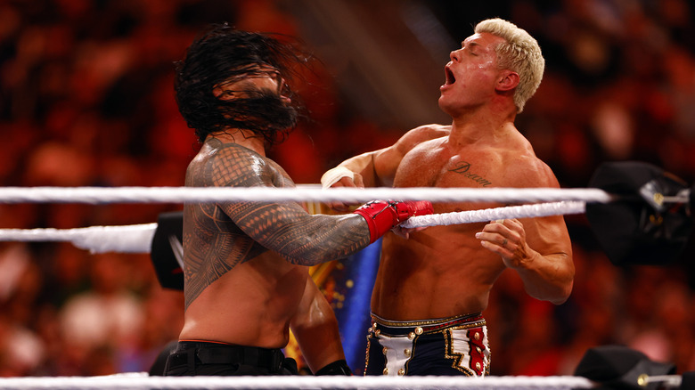 roman reigns fighting cody rhodes