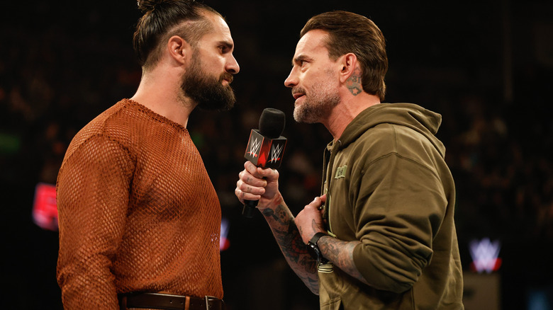 Seth Rollins and CM Punk speak during Monday Night RAW at Angel of the Winds Arena on December 2, 2024 in Everett, Washington.