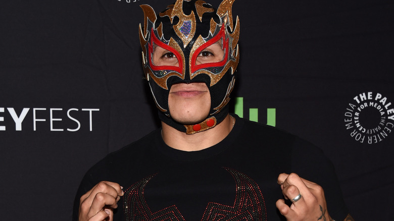 Rey Fenix wearing a black and gold mask