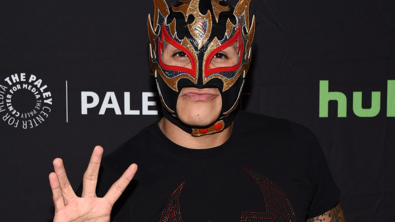 Rey Fenix wearing a black and gold mask