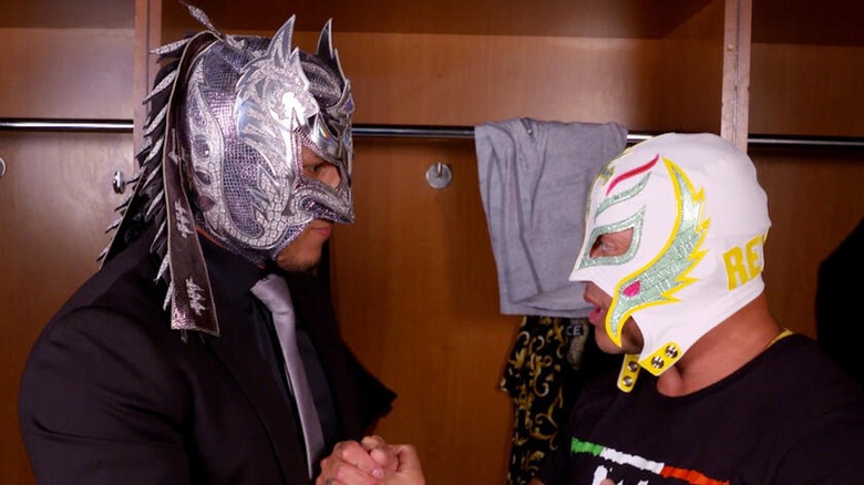 Dragon Lee and Rey Mysterio discuss strategy.