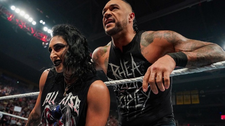 Damian Priest and Rhea Ripley stare up the ramp at Dominik Mysterio and Liv Morgan after the teams brawled in the ring during an episode of "WWE Raw."