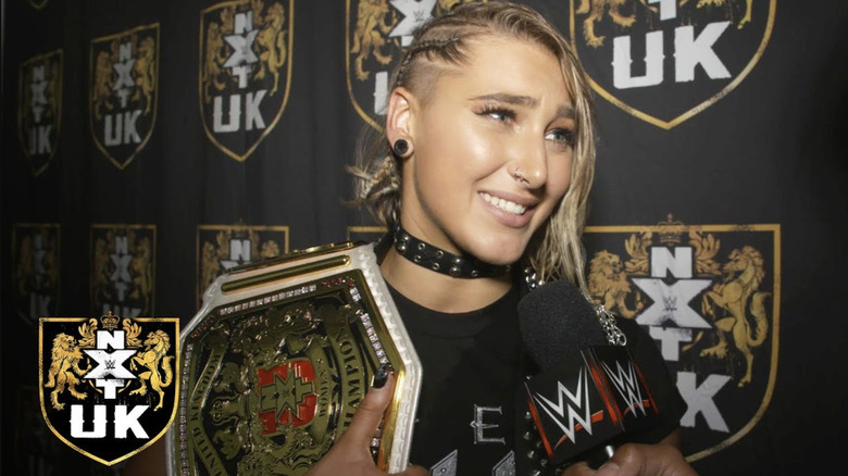 Rhea Ripley posing with her first title