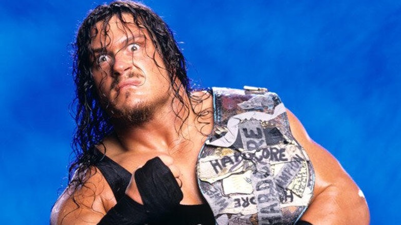 Rhyno posing with the WWE Harcore Championship for a promotional shoot