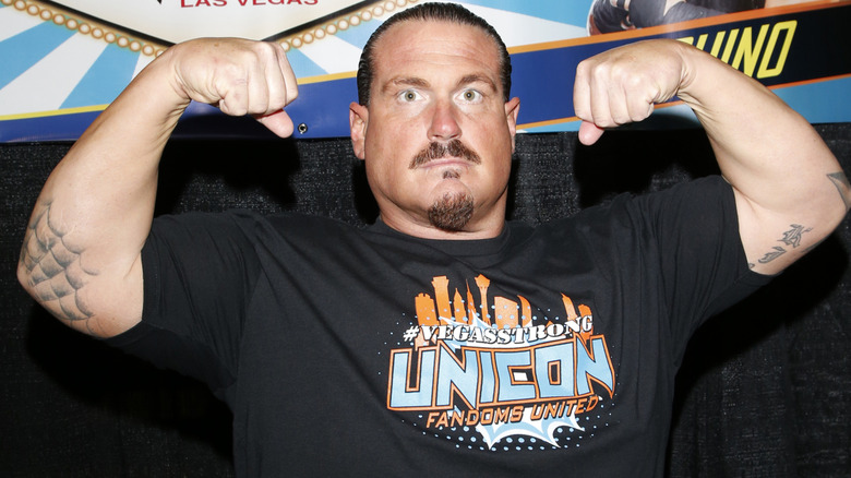 Rhyno flexing his arm muscles