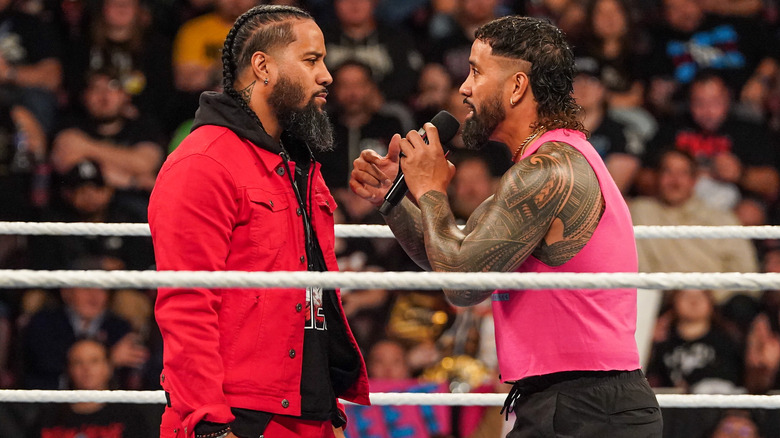 Jey Uso talking to Jimmy Uso in the wrestling ring