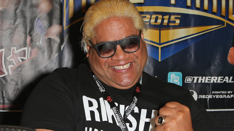 Rikishi wearing sunglasses and smiling