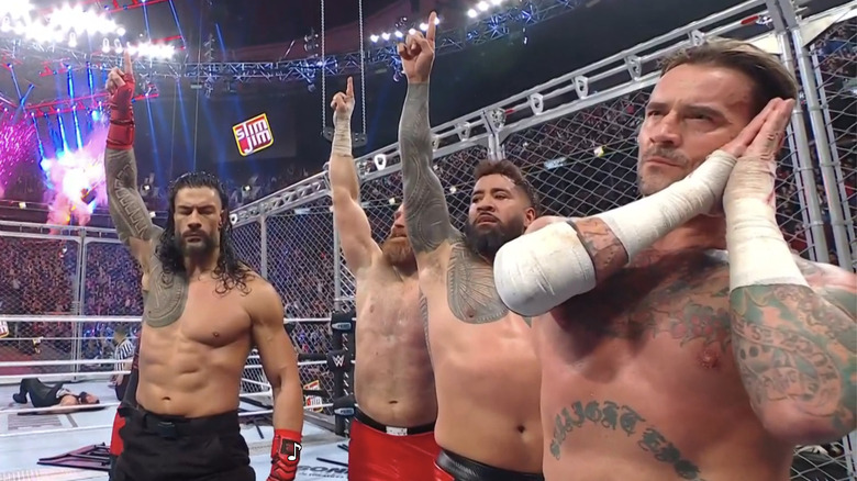 Roman Reigns, Sami Zayn, Jey Uso, and CM Punk all hit their signature poses inside the WarGames cage.