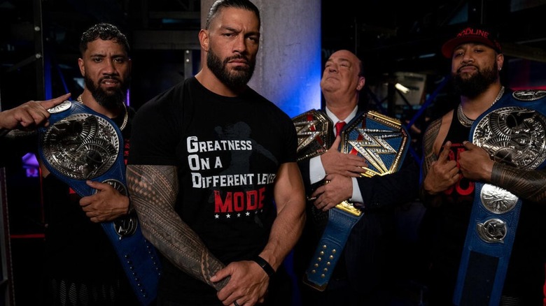 Roman Reigns poses backstage along with Jimmy and Jey Uso, as well as Paul Heyman, back in the days of the original Bloodline.