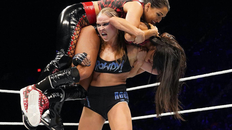 Ronda Rousey with both Bellas on her shoulders