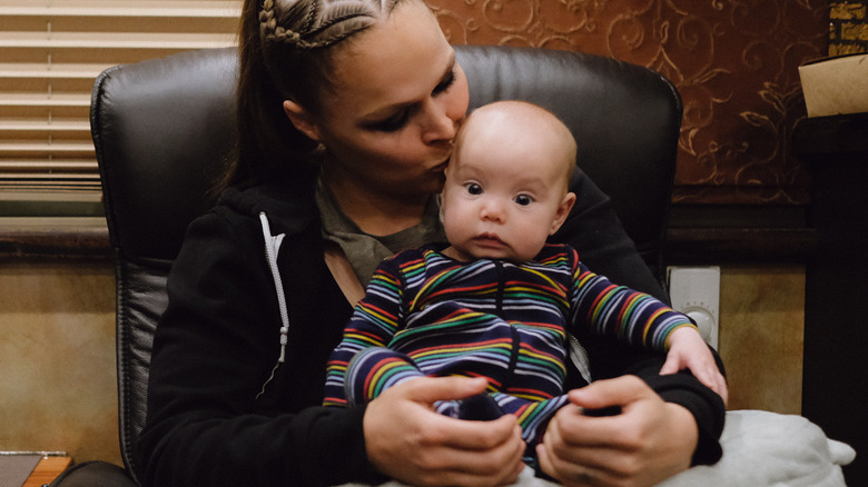 Ronda Rousey kissing her daughter