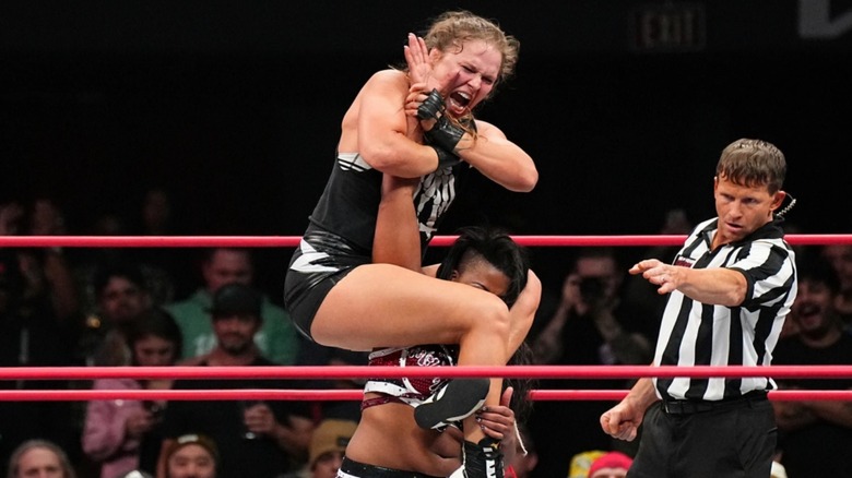 Ronda Rousey tries to submit Athena with an armbar