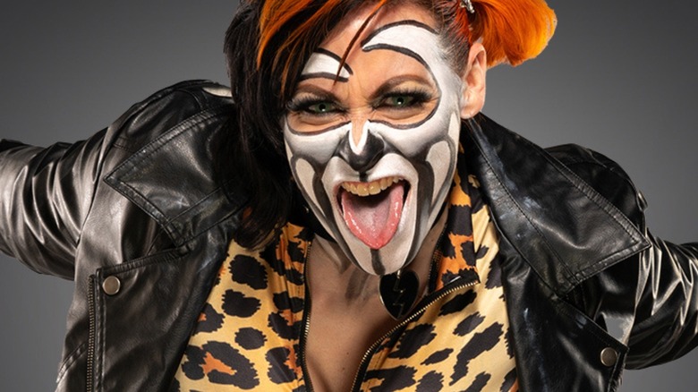 Rosemary poses for a camera backstage wearing face paint in TNA.