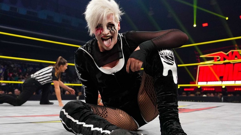 Rosemary sits in the ring and sticks her tongue out, posing for the camera during an episode of "TNA Impact."