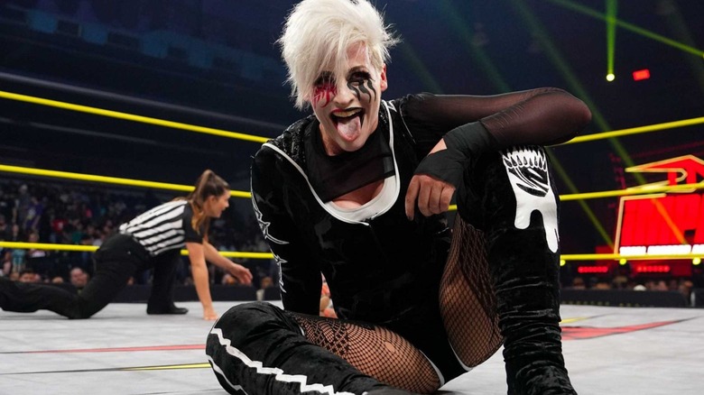 Rosemary sits in the ring and sticks her tongue out, posing for the camera during an episode of