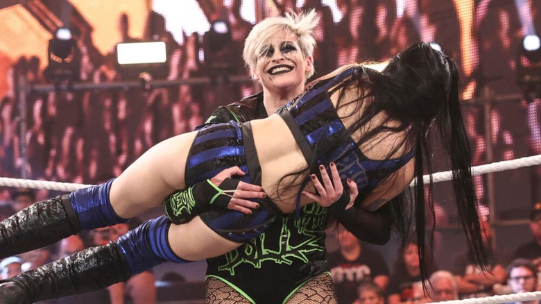 Rosemary holds up Tatum Paxley during a match in "WWE NXT."