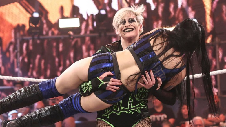 Rosemary holds up Tatum Paxley during a match in