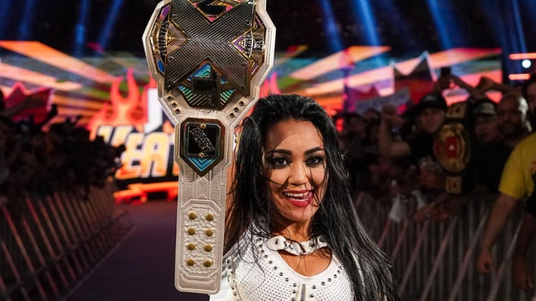 Roxanne Perez holds up her championship while standing on the ramp after a match at "WWE NXT" Heatwave.