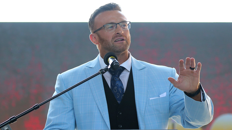 Nick Aldis, holding his hand slightly up