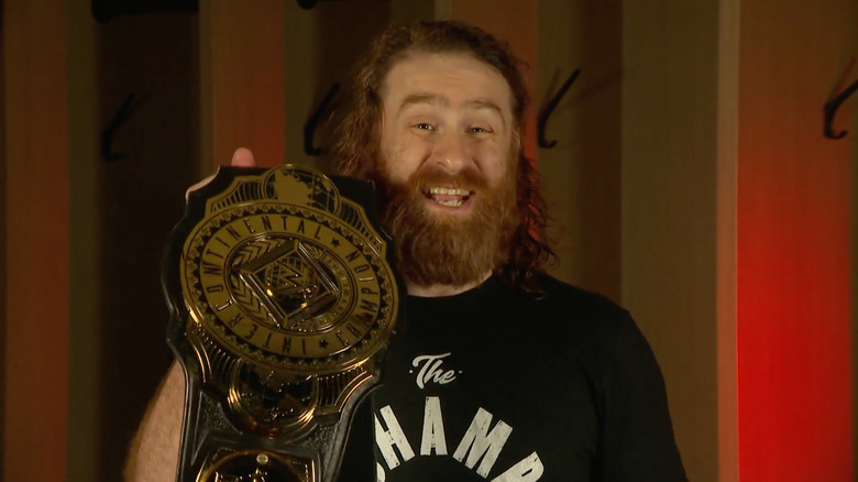 Sami Zayn holds up WWE Intercontinental Championship belt