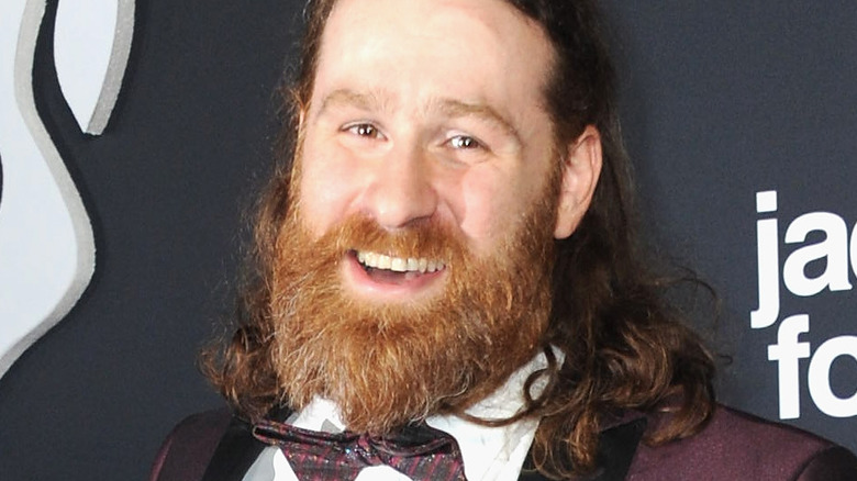 Sami Zayn in a bowtie smiling 