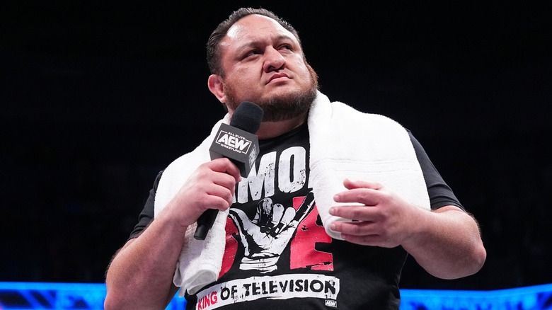 Samoa Joe holding a microphone