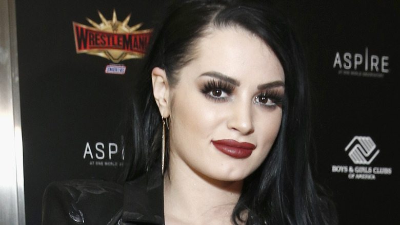 Saraya smiling with red lipstick on