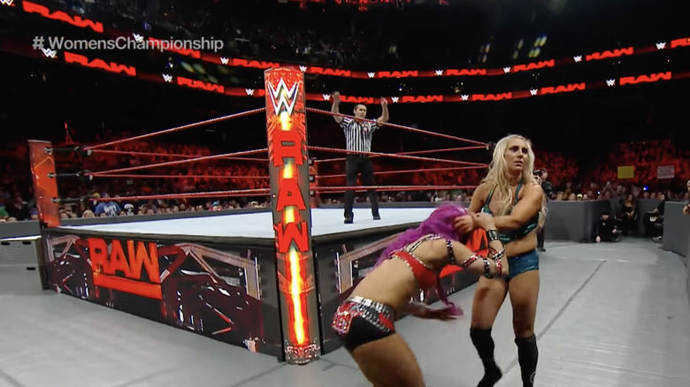 Charlotte Flair and Sasha Banks outside the ring