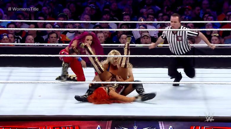 Sasha Banks rushes to keep Charlotte Flair from pinning Becky Lynch