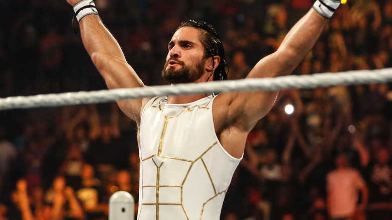 Seth Rollins with his arms up