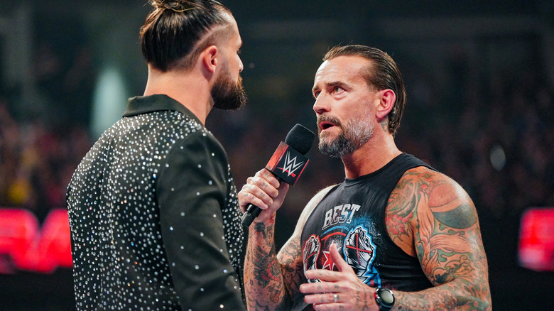 Seth Rollins and CM Punk face-off in the ring