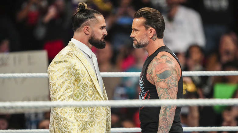 Seth Rollins and CM Punk staring at each other