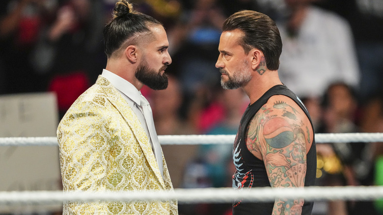 Seth Rollins and CM Punk staring off