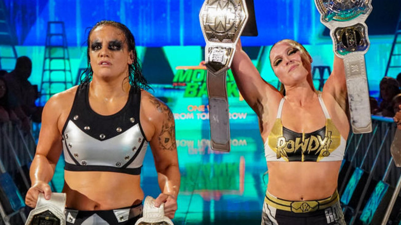 Shayna Baszler and Ronda Rousey holding tag titles