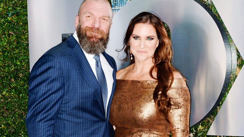 Stephanie McMahon stands beside her husband, Paul "Triple H" Levesque