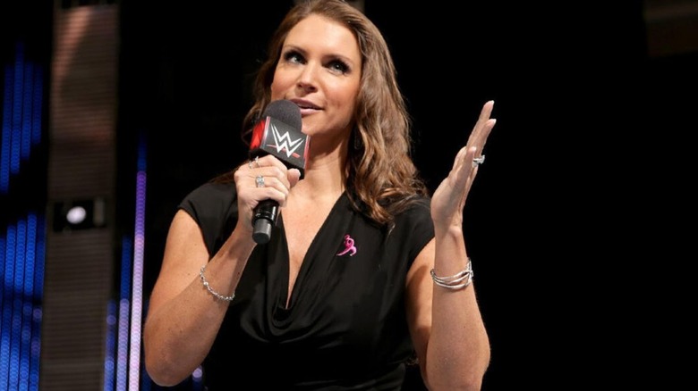 Stephanie McMahon holds a microphone