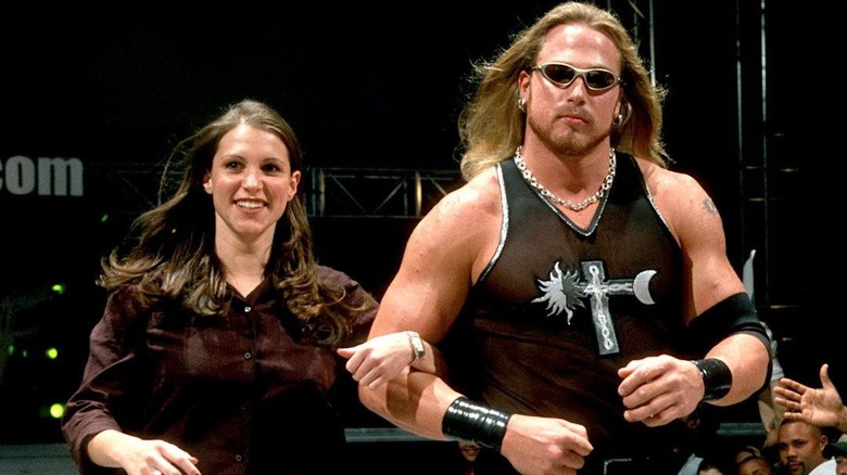 Stephanie McMahon and the late Andrew "Test" Martin walk down the ramp on Raw.