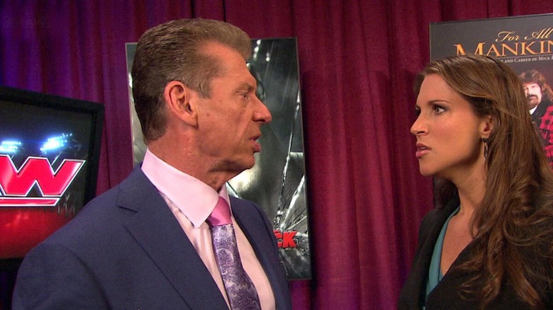Stephanie McMahon looks disgustedly at her father Vince.