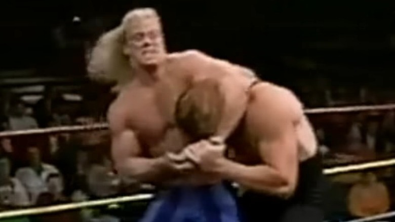 Steve Austin with the Punisher in a headlock