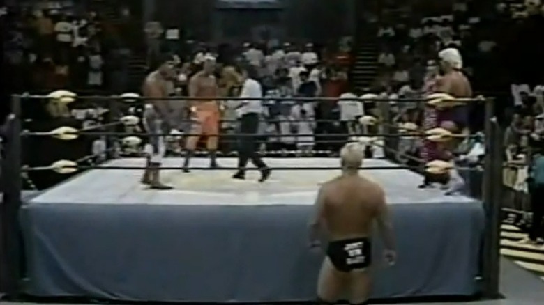 Steve Austin outside the ring, Ric Flair, Ricky Steamboat, and Sting inside the ring